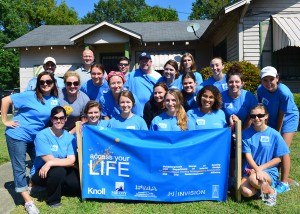 LSU interior design students participating in service learning project gather in group, wearing blue shirts